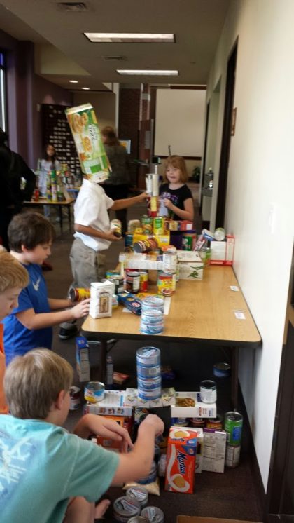 Youth working on Souper Bowl of Caring canstructions