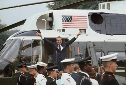 Pres. Richard Nixon resigns, gives victory sign as he leaves by helicopter.